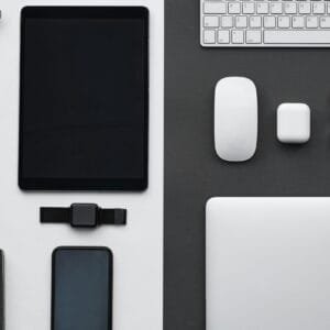 Stylish flatlay of modern tech gadgets including tablet, smartphone, smartwatch, and accessories.