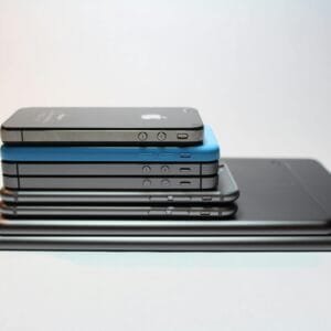 Stacked modern smartphones and tablets showcasing sleek design. Perfect tech background.
